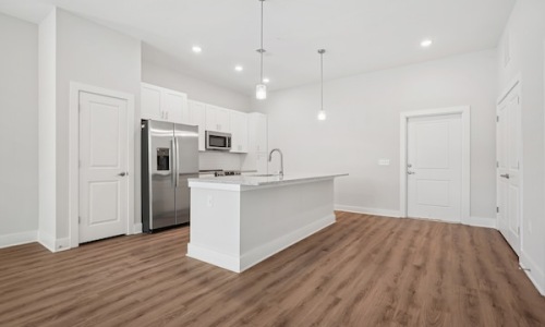 Spacious kitchens with thoughtful details a large kitchen with an island and wood floors