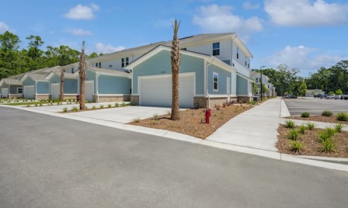 The essence of exceptional living a row of townhomes with a sidewalk and a street